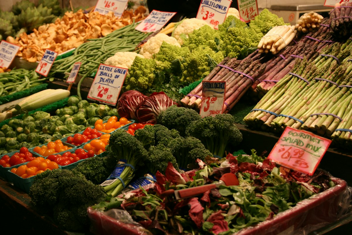 Fresh natural foods and ingredients supporting male wellness including vegetables, seeds, and whole foods